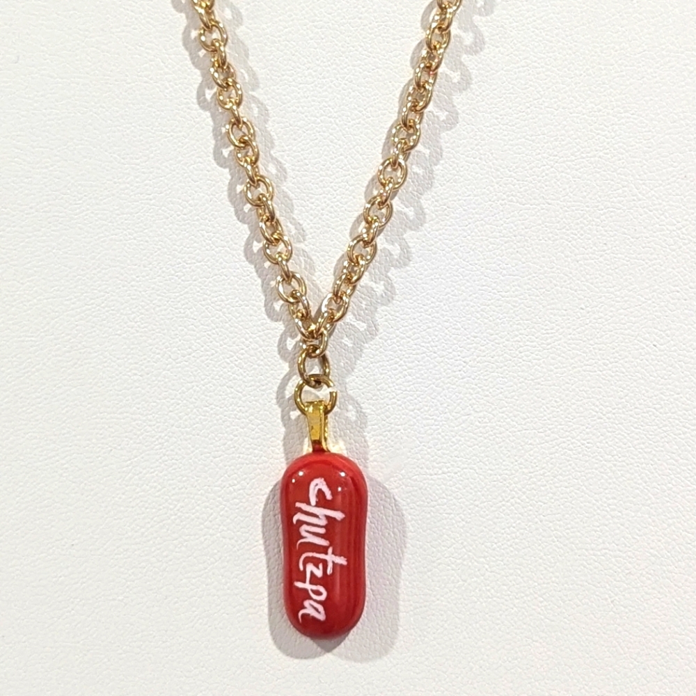 Hand crafted artisan made one of a kind Chutzpa necklace in red. gold plated.